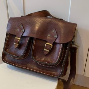 Hard leather book bag brown.